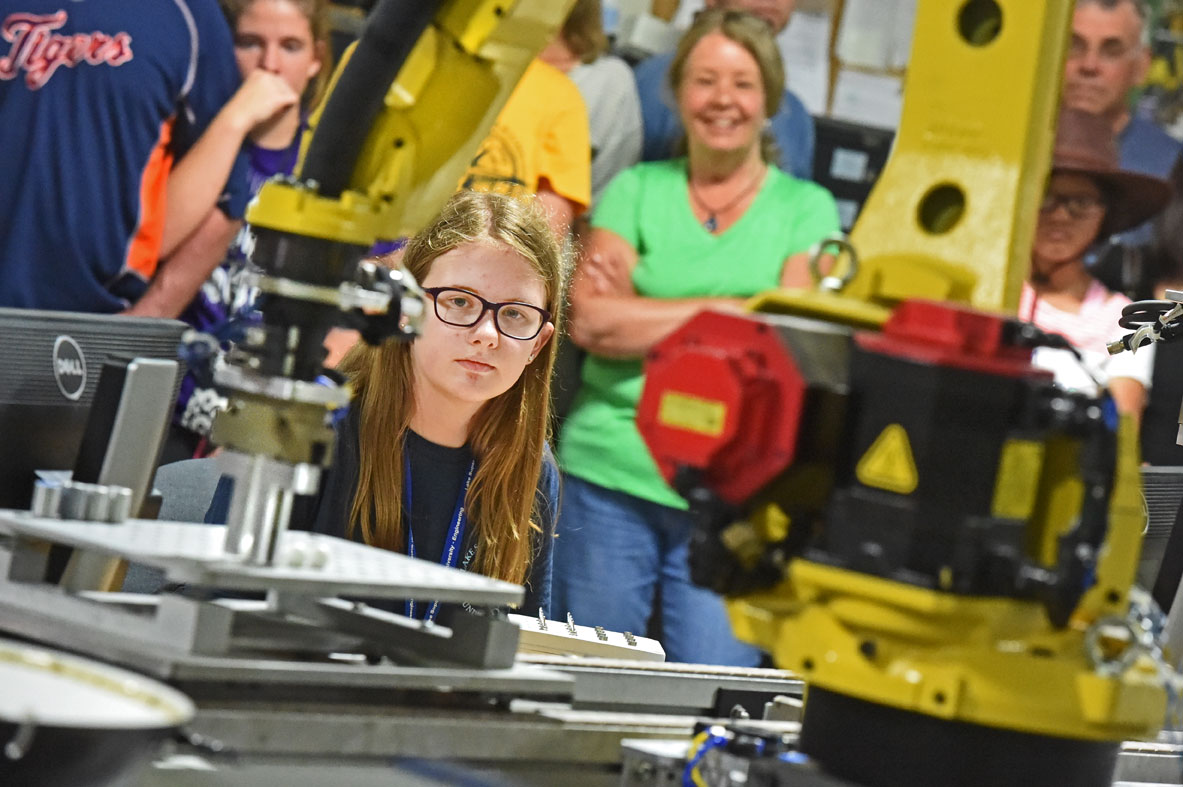 Paige Dugas keeps a sharp eye on her FANUC M10 robot