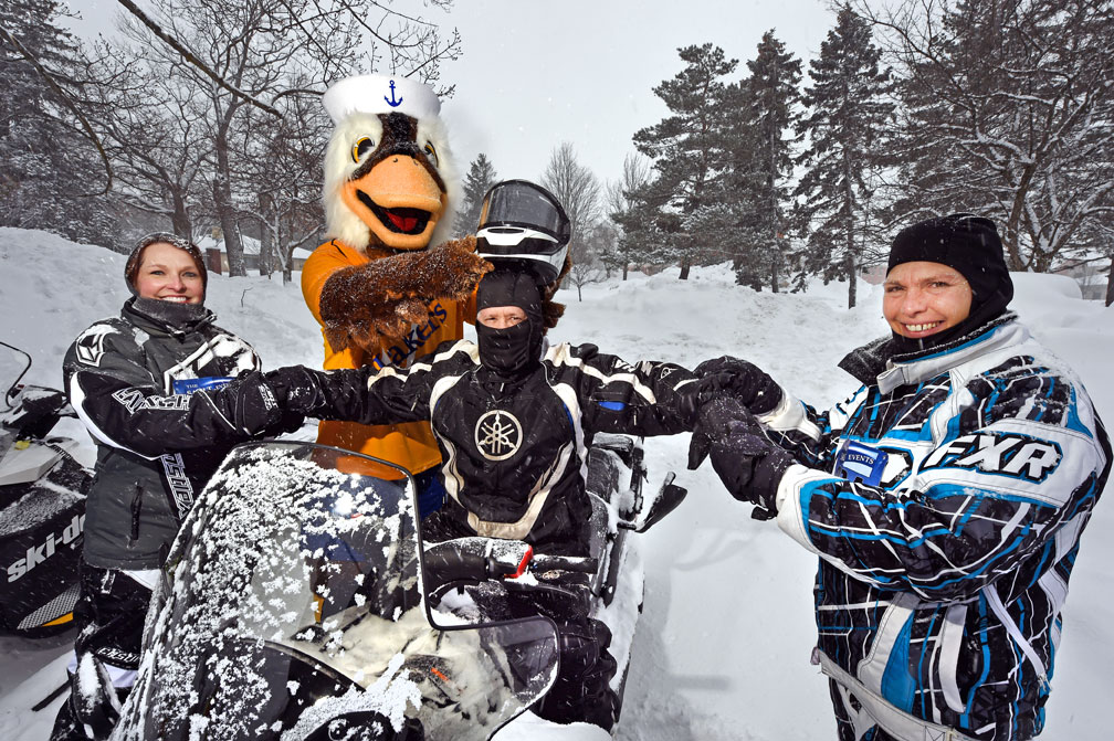 Pres. Mitchell readies on snowmobile