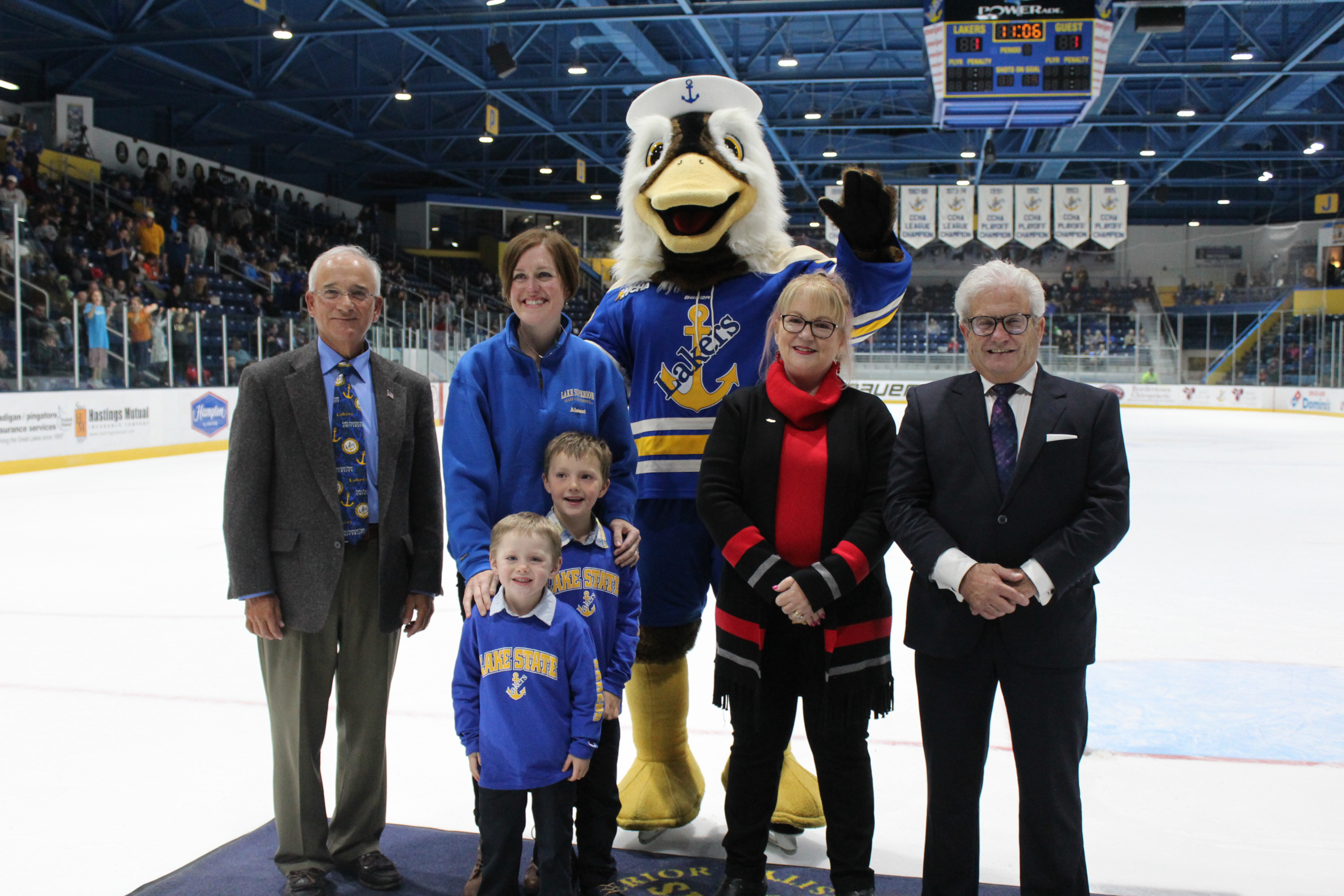 Alumni who were recognized stand on the ice during the GLSW hockey match